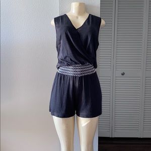 New woman’s black romper with white elastic waist.
